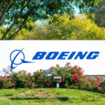 Boeing logo on sign with flowers and trees