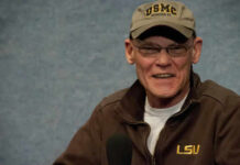 Man wearing a cap and a jacket smiling