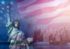 Statue of Liberty in front of a blurred New York City skyline with an overlay of the American flag