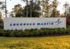 Lockheed’s Gamble: Will F-22 Upgrades Pay Off? Sign displaying the Lockheed Martin logo in a landscaped area
