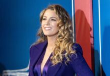 Lively’s Court Setback: Major Claims Axed A smiling woman in a purple outfit posing at an event