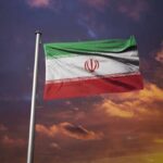 Iran’s Bounty Strategy: Civilians as War Tools Iranian flag waving against a sunset sky