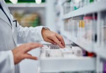 Pharmacist organizing medication on a shelf