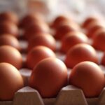 Close-up of brown eggs arranged in a carton