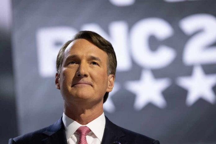 shutterstock_2519820795.jpg A man in a suit giving a speech at a political conference