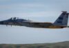 F-15 Eagle military aircraft flying against a clear sky