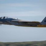 F-15 Eagle military aircraft flying against a clear sky