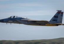 F-15 Eagle military aircraft flying against a clear sky