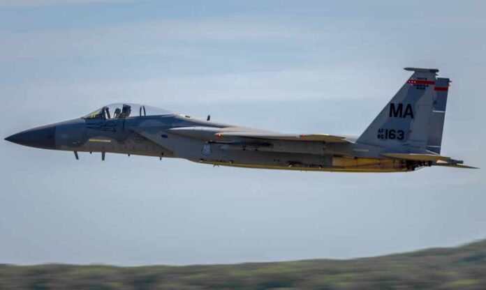 F-15 Eagle military aircraft flying against a clear sky