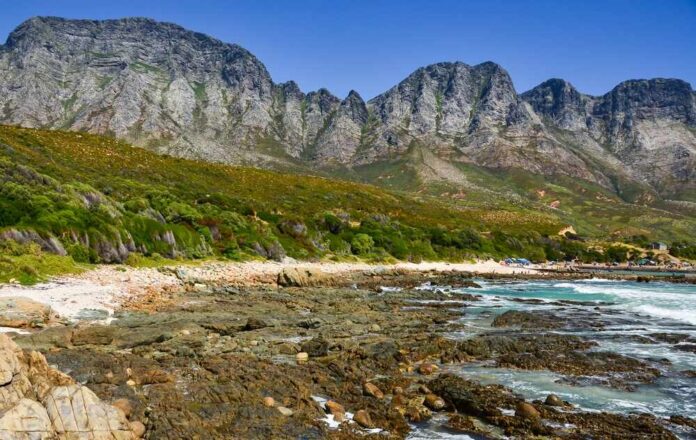 Scenic view of a rocky beach with mountains in the background