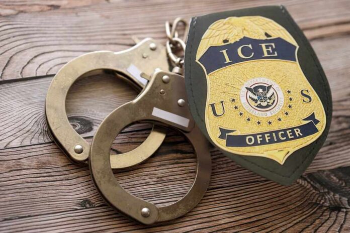 Handcuffs and a police badge on a wooden surface