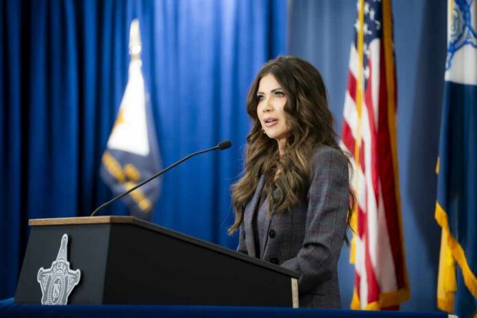 A woman speaking at a podium during a press conference