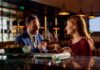 A couple toasting with wine glasses at a restaurant