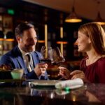 A couple toasting with wine glasses at a restaurant