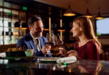 A couple toasting with wine glasses at a restaurant