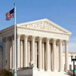 United States Supreme Court building with American flag