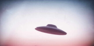 UFO flying over mountains during sunset or sunrise