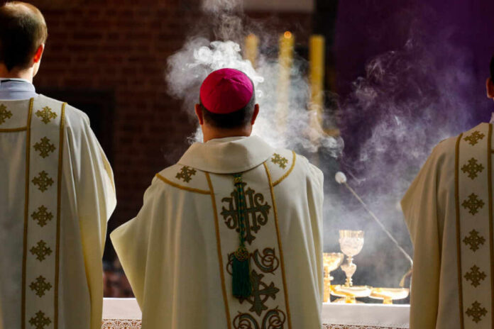 Torun,Poland,-,April,18,,2019:,Bishop,Censes,Incense,During Clergy in ornate vestments during a church service with incense smoke