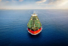 Oil tanker sailing straight through calm open sea