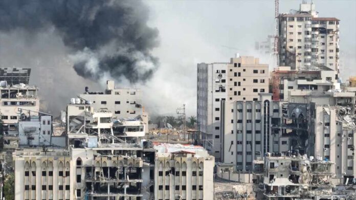 Smoke,Rising,Behind,Destroyed,Buildings,In,Gaza,,Aerial,View,Drone A view of destroyed buildings with smoke rising in the background