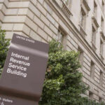 IRS building sign outside government building with greenery