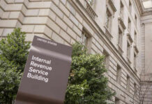 IRS building sign outside government building with greenery