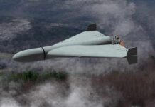 Iran’s Drone Assault: UAE Energy Sites Ablaze Flying wing drone with pusher propeller over foggy forest