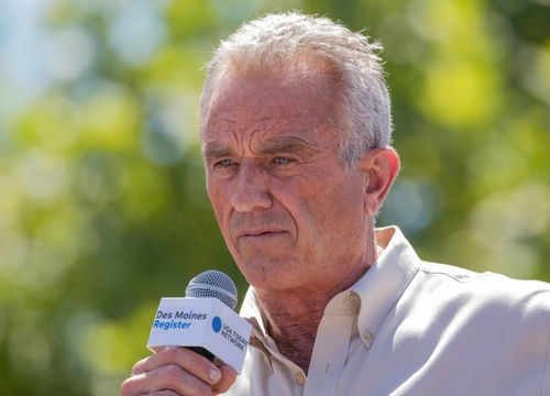 Man speaking into microphone at outdoor event