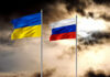 Ukrainian and Russian flags on poles against a dramatic cloudy sky