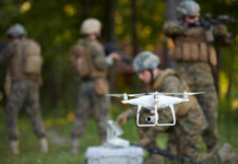 A military drone being prepared for use with soldiers in the background
