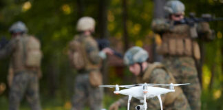 A military drone being prepared for use with soldiers in the background