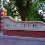 Entrance sign of Smith College surrounded by greenery