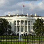 The White House with an American flag flying above it