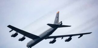 A B-52 bomber flying in the sky with visible jet engines