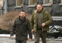 Two men in winter jackets walking outdoors in an urban area