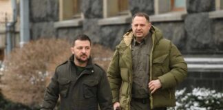 Two men in winter jackets walking outdoors in an urban area