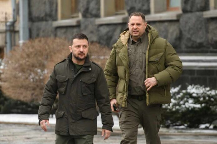 shutterstock_2417356397.jpg Two men in winter jackets walking outdoors in an urban area