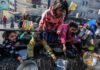 Children reaching for food during a distribution event