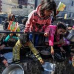 Children reaching for food during a distribution event