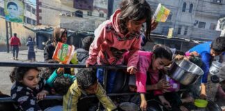 Children reaching for food during a distribution event