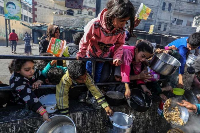 Children reaching for food during a distribution event