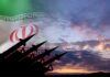 Silhouette of missiles in front of the Iranian flag during sunset