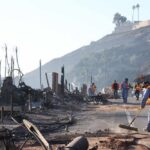Massive Legal Battle: LA Faces Wildfire Fallout Workers cleaning up debris from a wildfire-affected area