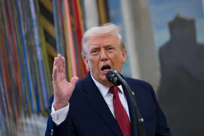 A man speaking passionately into a microphone with his hand raised