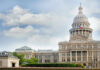 Capitol building with dome under partly cloudy sky.