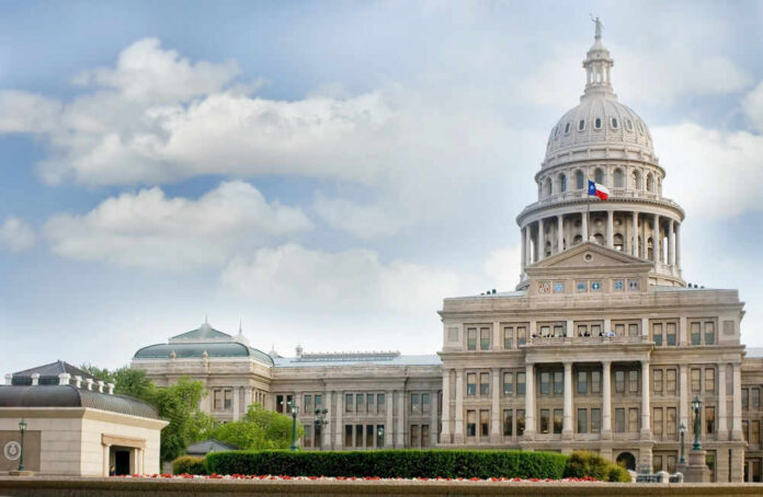 Capitol building with dome under partly cloudy sky.