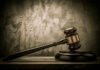 Judges gavel on a dark wooden surface.