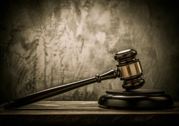 Judges gavel on a dark wooden surface.