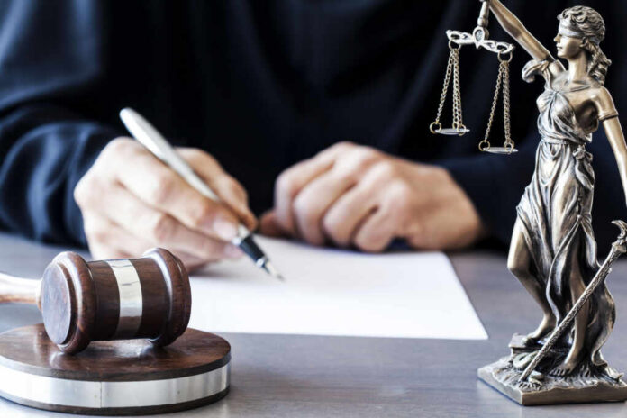 Gavel statue of justice person writing document
