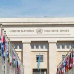 United Nations building with rows of world flags